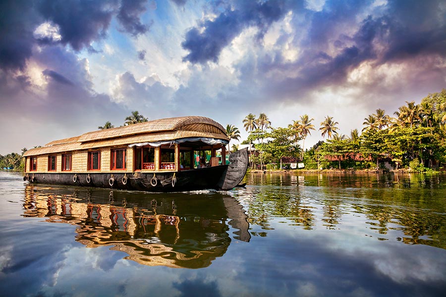 traditional, thatch-roofed Kettuvallam houseboat